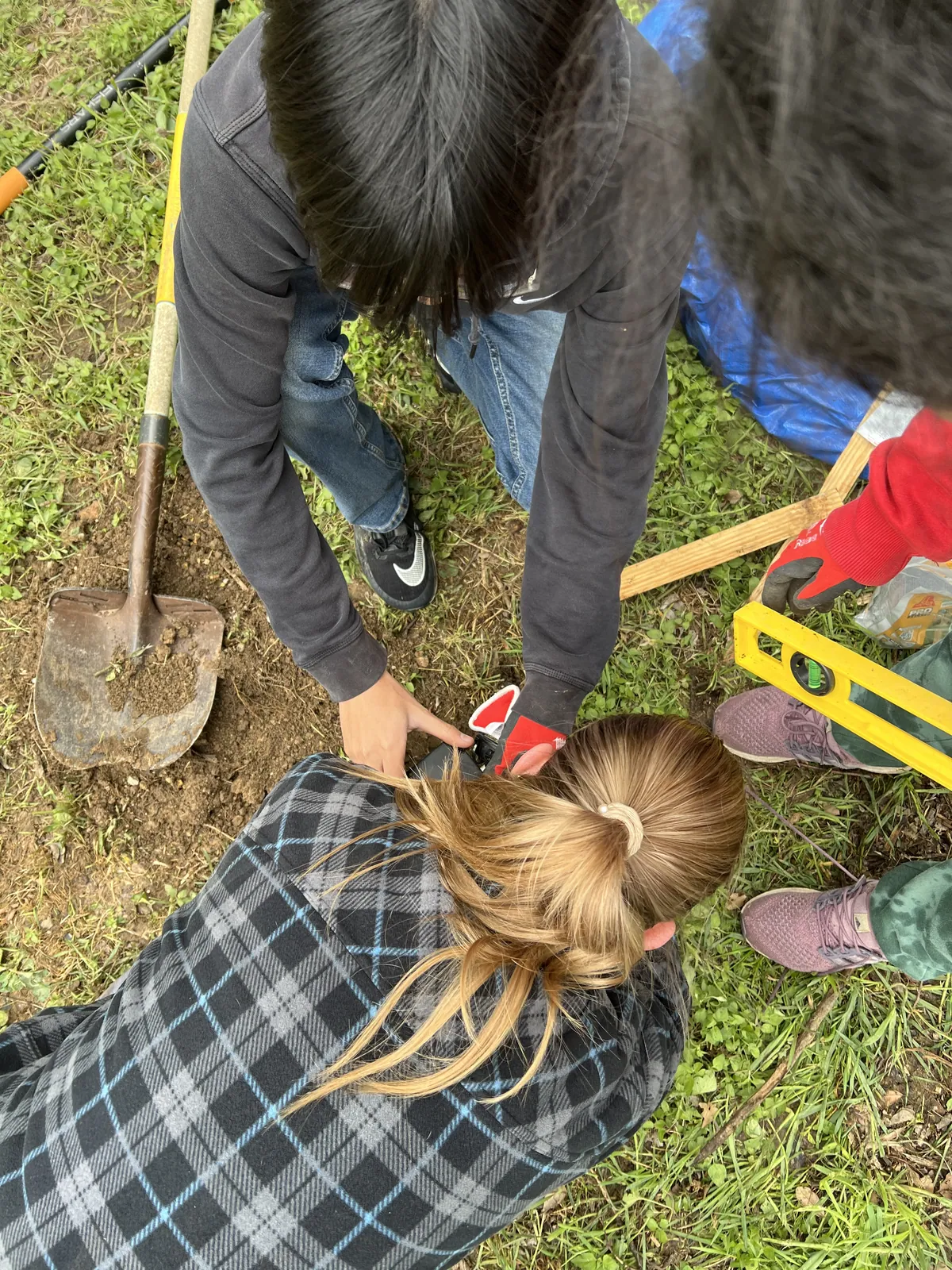 Volunteers digging to set a post